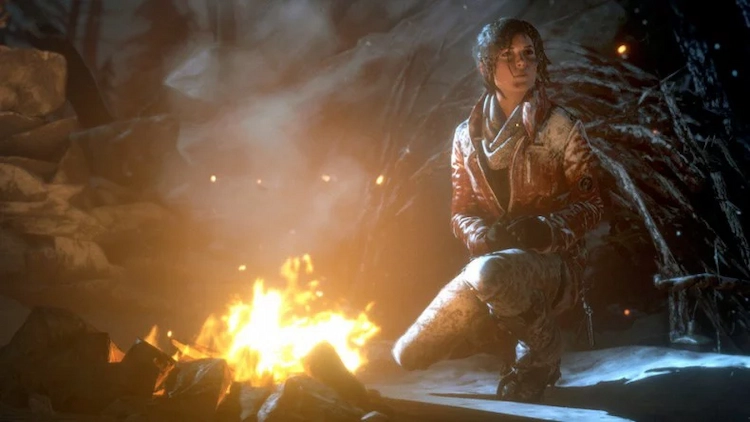 El esencial Autoguardado. Imagen promocional de Tomb Raider con Lara cerca de una hoguera.