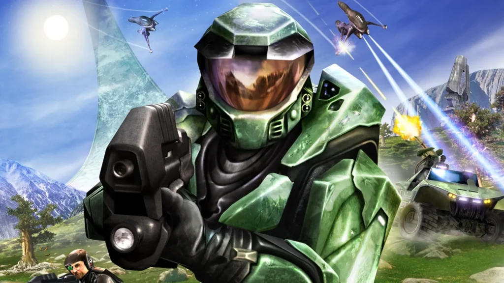 El E3 al caer - Un repaso a la saga "Halo" 2 Un soldado con una armadura verde apuntando con una pistola a cámara, teniendo una batalla de fondo. Ejemplo de lo que es un repaso a la saga Halo.