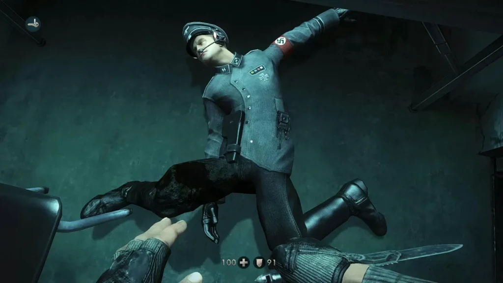 Enemigo nazi derrotado tumbado en suelo turquesa en primera persona en Wolfenstein: The New Order.