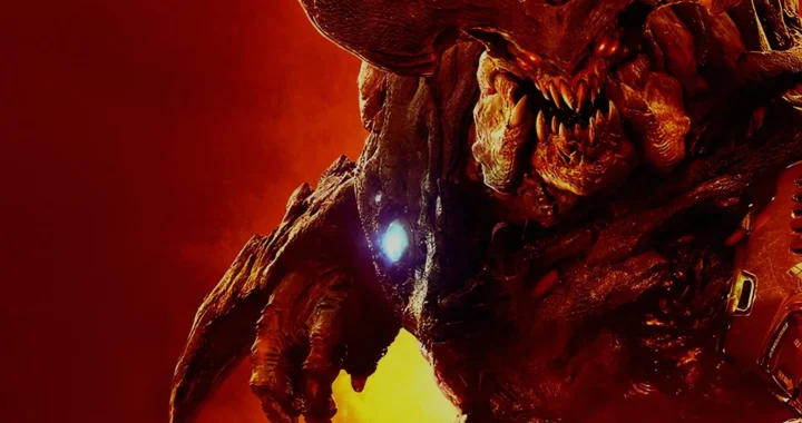 Un demonio colosal ruge entre fuego y sombras en la beta cerrada de Doom, mostrando su ferocidad con ojos rojos y colmillos afilados.