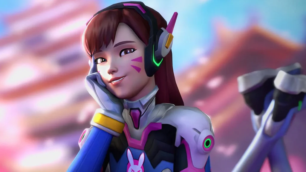 Primer plano de la heroína D.Va haciendo un gesto adorable con la mano en la cara en una cinemática de Overwatch.