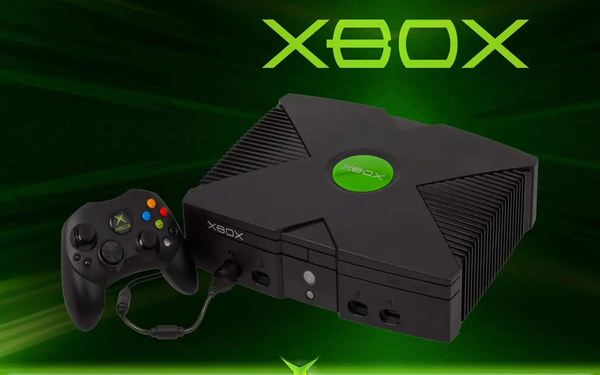 La consola Xbox original y su mando aparecen sobre un fondo verde para celebrar 15 años de Xbox.