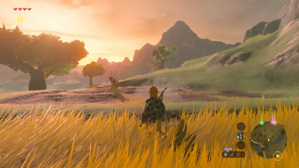 El jugador (Link) avanza oculto entre la hierba alta en el atardecer, destacando la belleza y la exploración del Viaje en Zelda en Breath of the Wild.