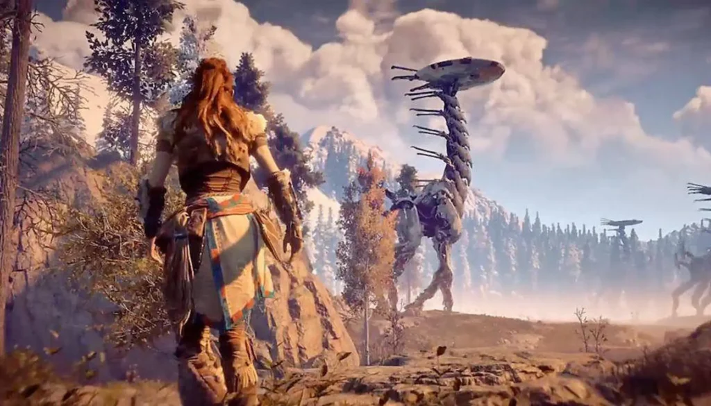 La protagonista Aloy observa a un enorme robot, un Cuellilargo, que se alza sobre un paisaje montañoso y boscoso, típico de Horizon Zero Dawn.