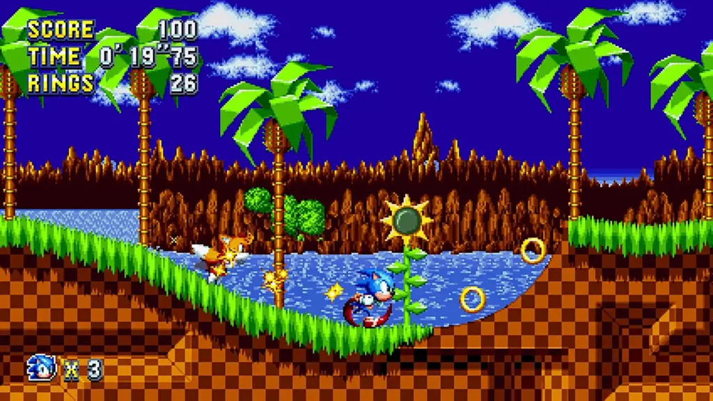 Sonic y Tails corren juntos en Green Hill Zone en una captura de gameplay de Sonic Mania con anillos dorados.