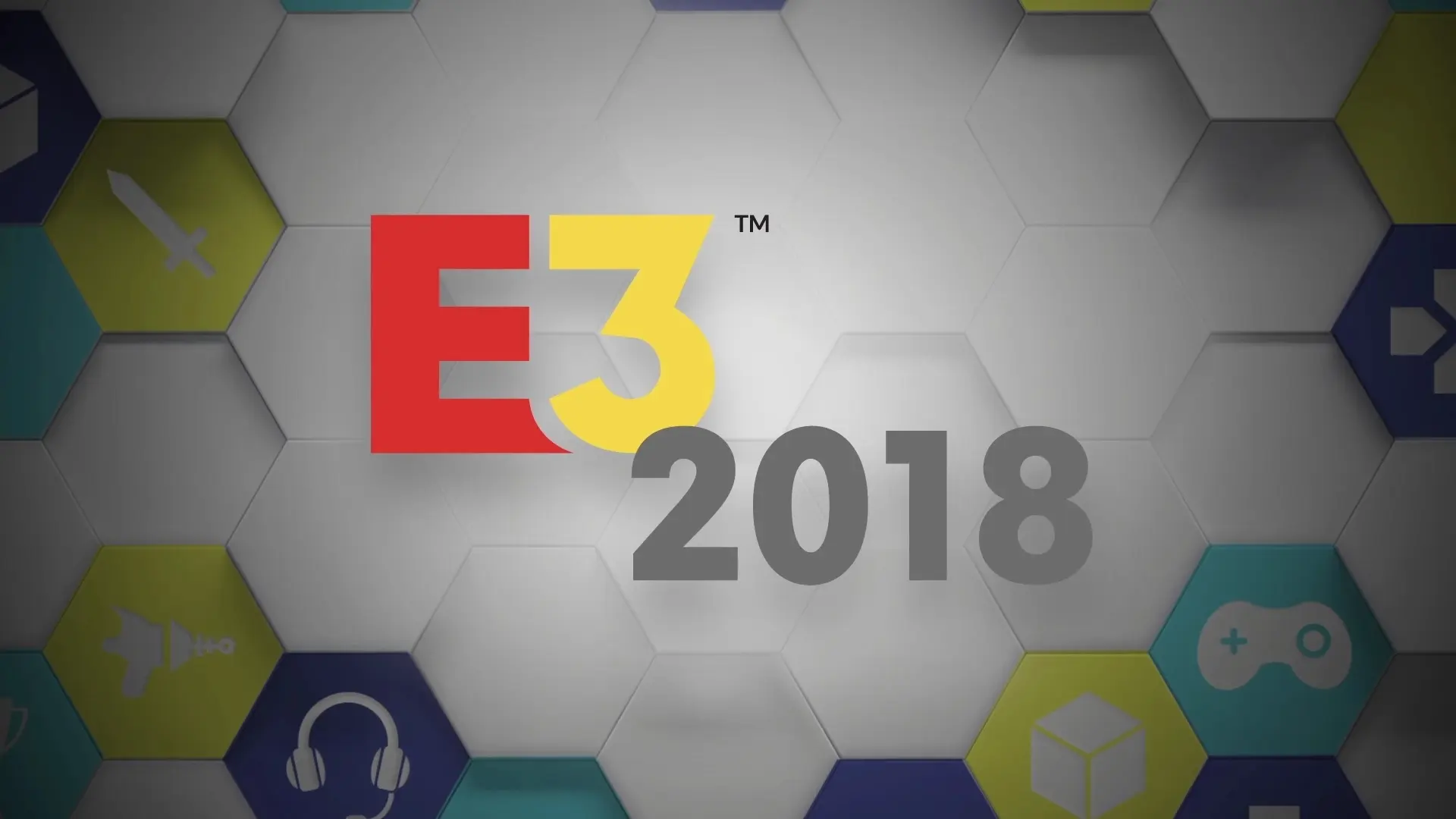 Cartel para presentar el E3 2018 con rombos blancos y de colores con símbolos de videojuegos.