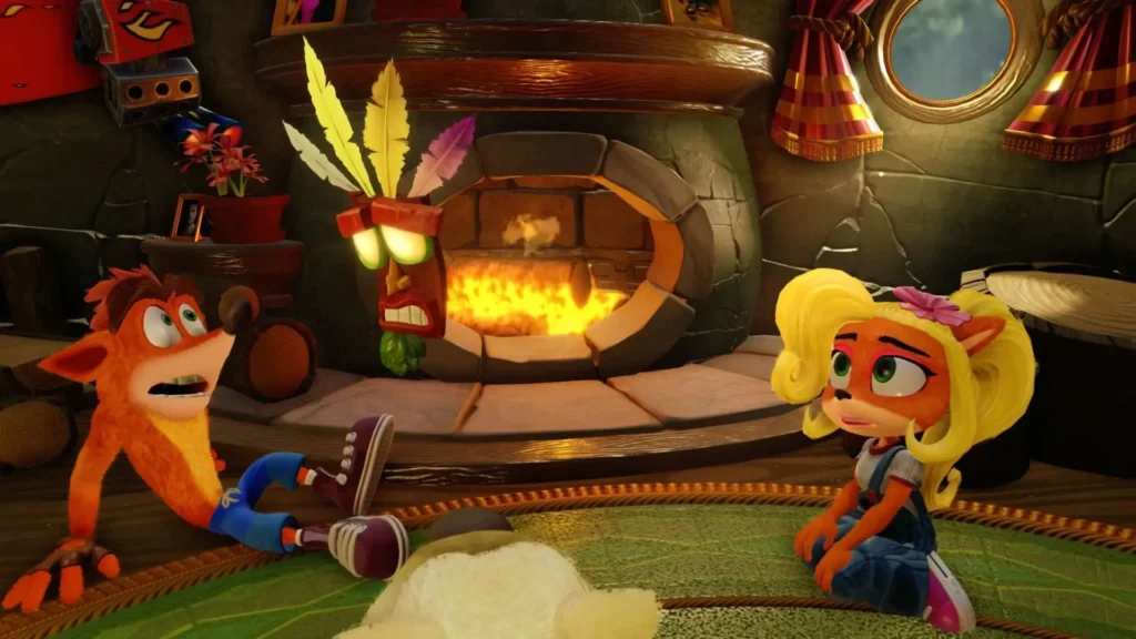 Crash Bandicoot y su hermana Coco se encuentran sentados en el suelo de una acogedora cabaña, discutiendo un problema mientras Aku Aku flota a su lado frente a una chimenea encendida.