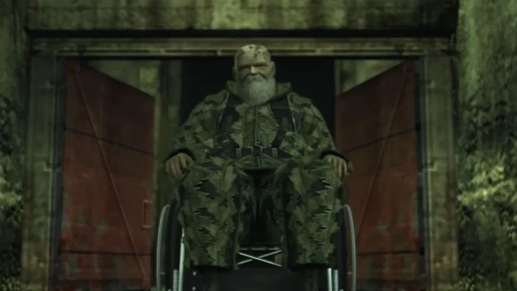El anciano francotirador The End de Metal Gear Solid 3: Snake Eater, con barba y uniforme de camuflaje, está sentado en una silla de ruedas frente a una puerta de búnker.