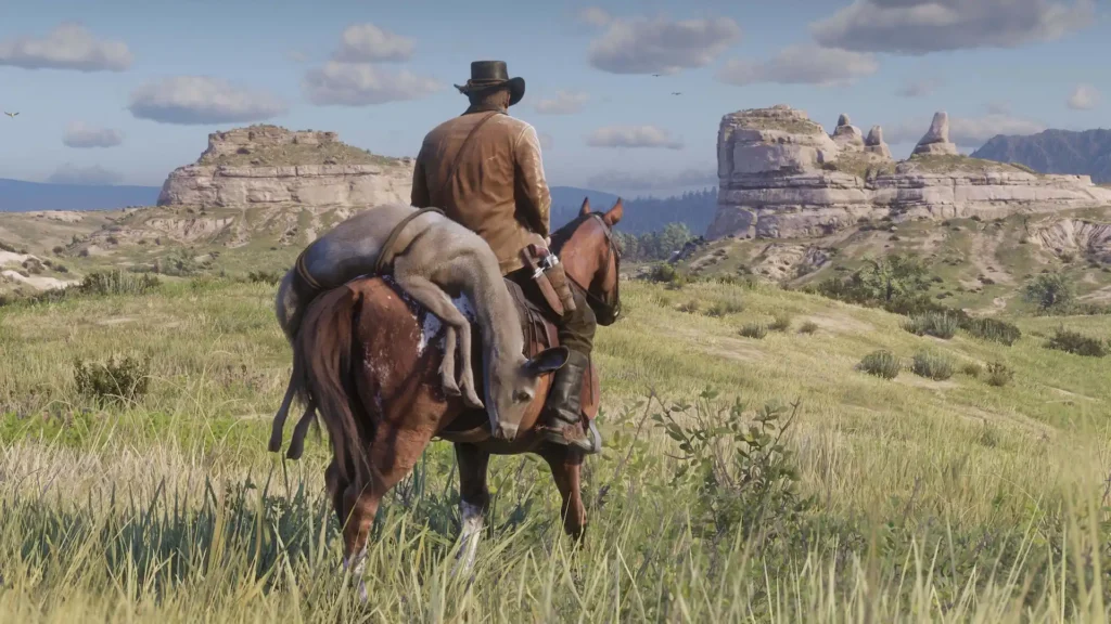Arthur Morgan cabalga con una presa al lomo por las praderas rocosas del mundo abierto de Red Dead Redemption 2.